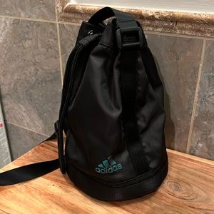 Black Adidas bag with cinch closure, adjustable shoulder strap